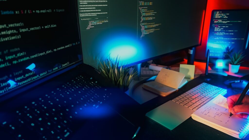 Modern software developer workstation with multiple screens displaying code