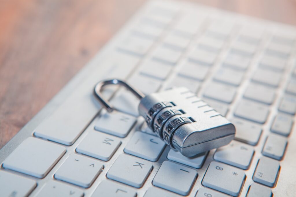 Padlock resting on a laptop computer keyboard representing data privacy and security