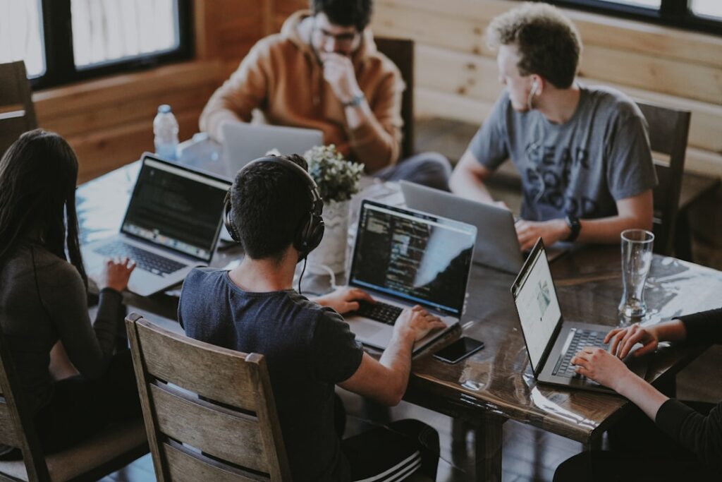 Team collaborating on laptops in a modern workspace